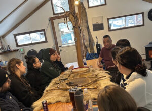 Étudiantes et étudiants qui discutent et apprennent avec un intervenant lors de d’immersion au sein d’une communauté innue de la Côte‑Nord.